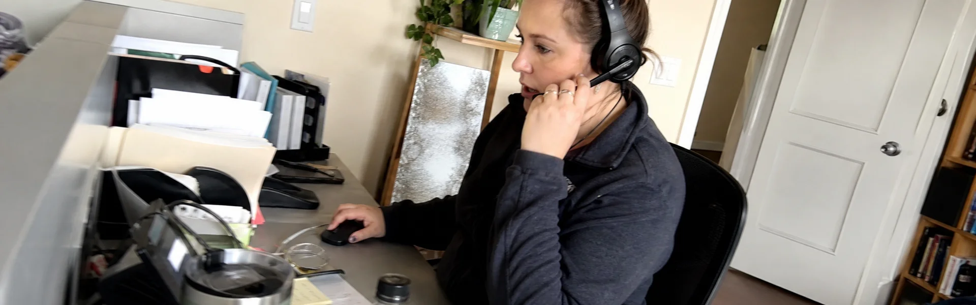 Dispatcher on a headset at Castle Rock Water Restoration Pros 24/7 line