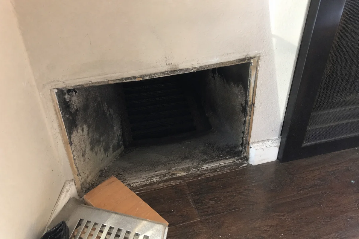 Soot-lined duct interior after fire damage