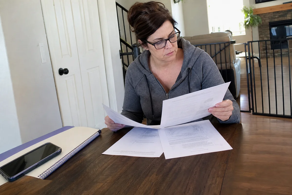 Homeowner reviewing mold estimate and insurance policy